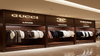 Inside a clothing store, a prominent display showcases a variety of colorful clothes arranged neatly.