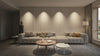 Modern living room with a neutral-toned sofa, textured wall panels, and soft lighting. A round wooden coffee table and a smaller white table add simplicity.